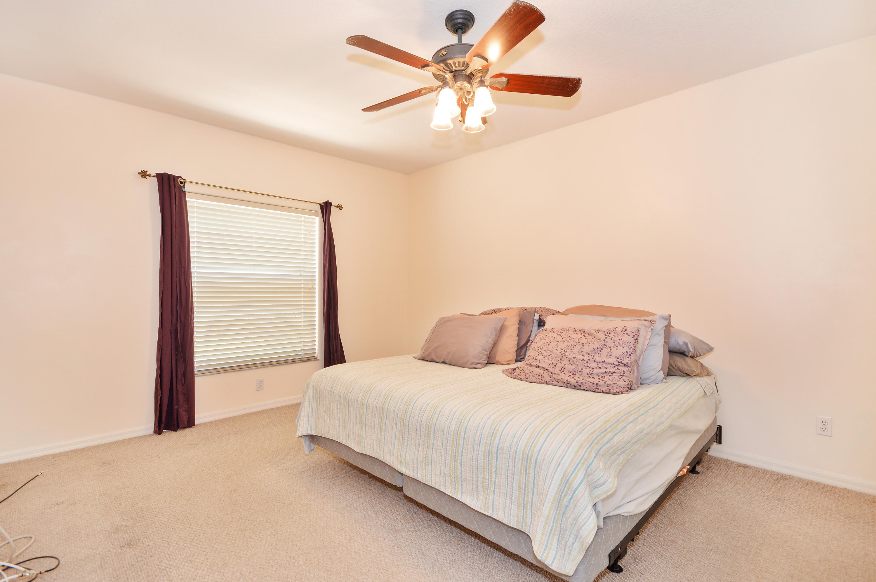 1132 Canoe Point Delray Beach, FL 33444 - Photo 8 of 16 a bedroom with a large bed and a chandelier
