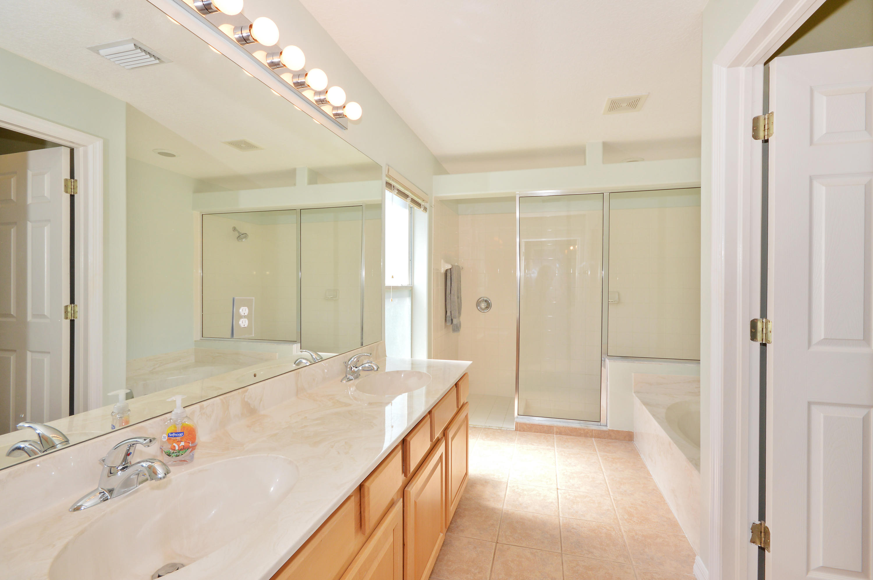 1132 Canoe Point Delray Beach, FL 33444 - Photo 9 of 16 a bathroom with a tub sink and mirror