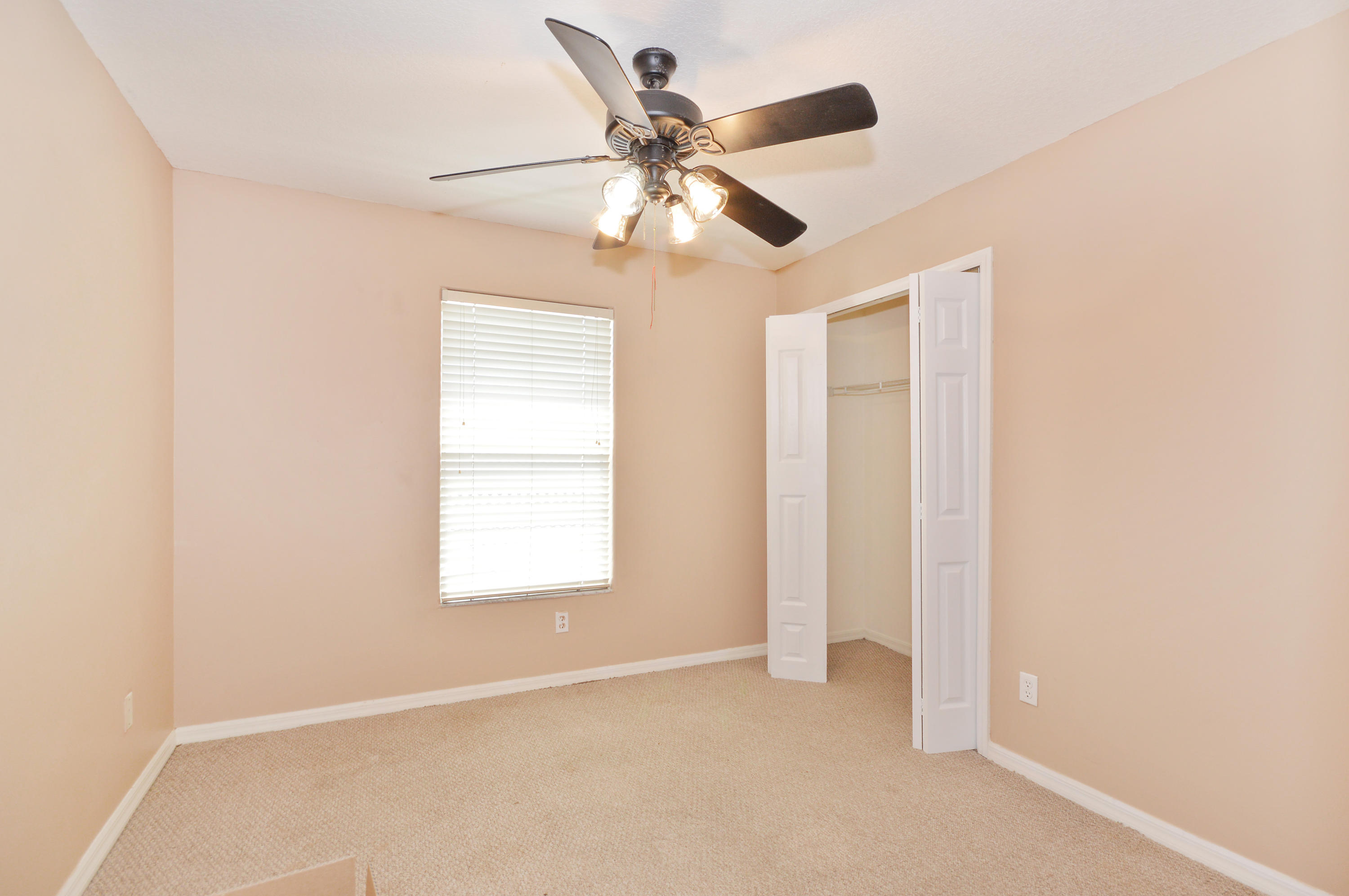 1132 Canoe Point Delray Beach, FL 33444 - Photo 10 of 16 an empty room with windows and fan