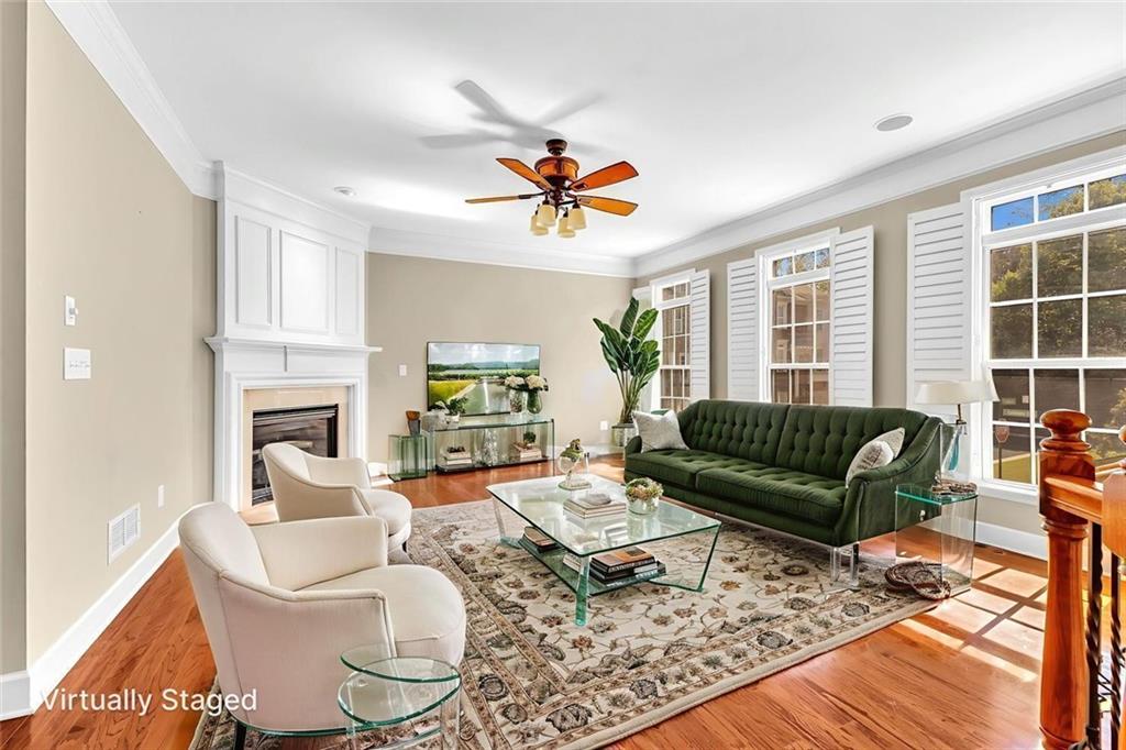 4888 Colchester Court, Unit 163 Atlanta, GA 30339 - Photo 2 of 44 a living room with furniture a fireplace and a flat screen tv