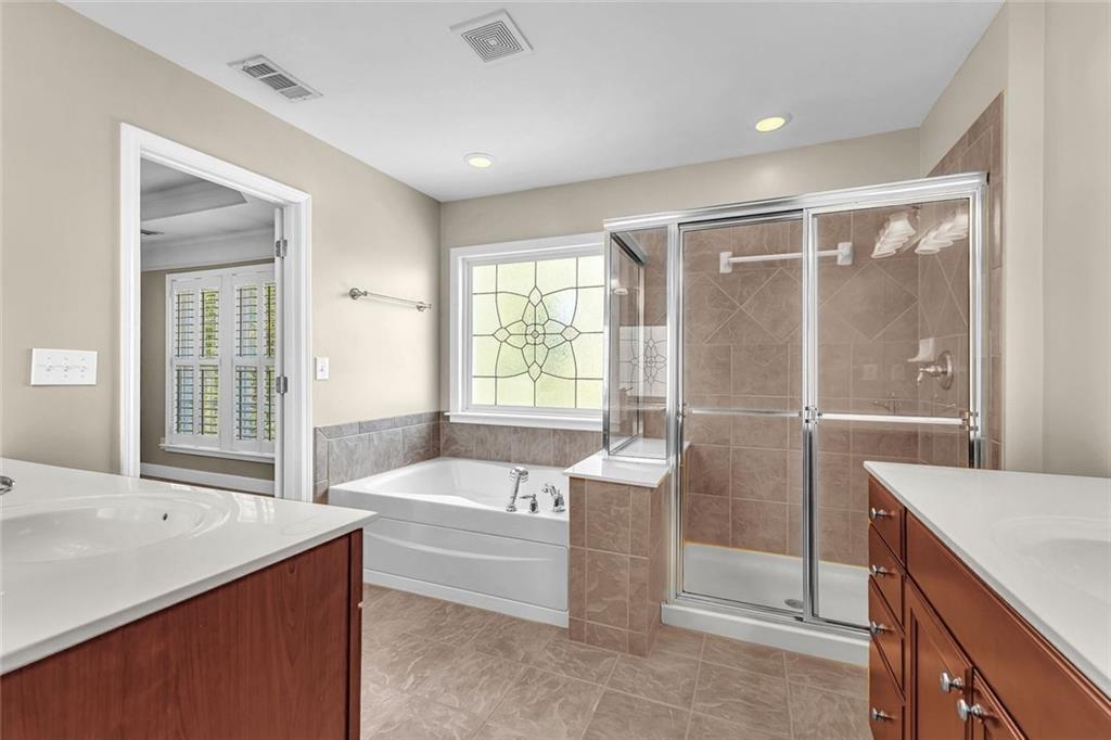 4888 Colchester Court, Unit 163 Atlanta, GA 30339 - Photo 21 of 44 a spacious bathroom with a tub sink and mirror