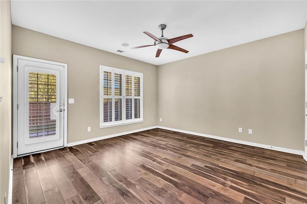 4888 Colchester Court, Unit 163 Atlanta, GA 30339 - Photo 28 of 44 a view of an empty room with wooden floor and a window