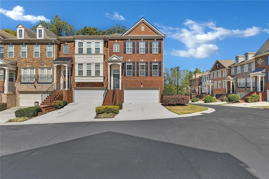 4888 Colchester Court, Unit 163 Atlanta, GA 30339 - Photo 40 of 44 a view of a brick house with a yard and plants