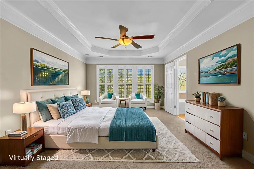 4888 Colchester Court, Unit 163 Atlanta, GA 30339 - Photo 4 of 44 a spacious bedroom with a bed a dresser and a flat screen tv