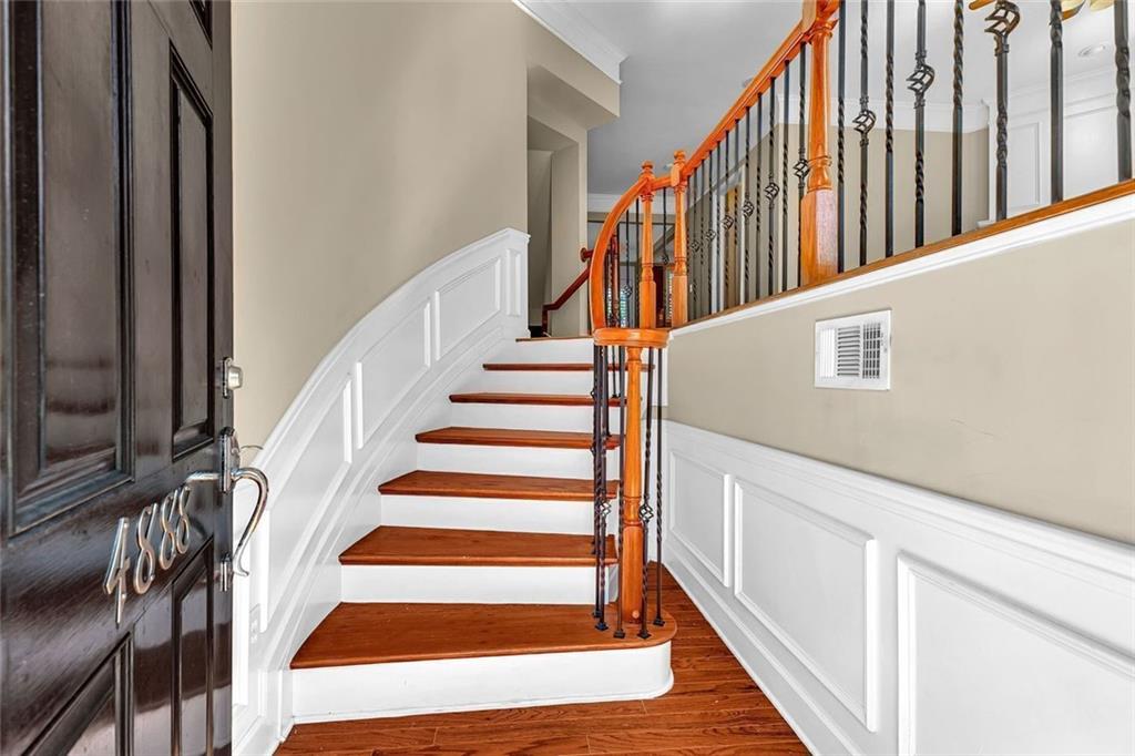 4888 Colchester Court, Unit 163 Atlanta, GA 30339 - Photo 7 of 44 a view of staircase with wooden floor and white walls