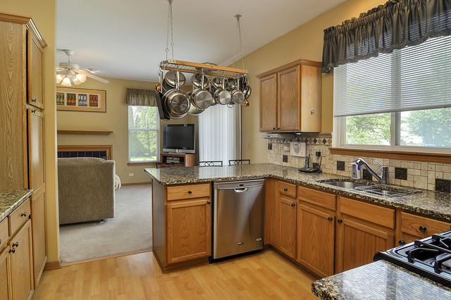 1056 Teasel Lane Aurora, IL 60504 - Photo 11 of 25 a kitchen with a sink stove and refrigerator
