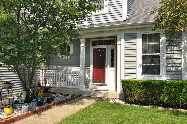 1056 Teasel Lane Aurora, IL 60504 - Photo 2 of 25 a front view of a house with a yard