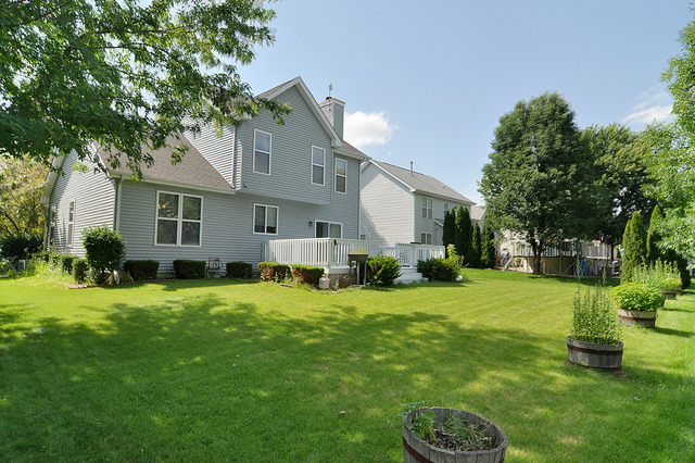 1056 Teasel Lane Aurora, IL 60504 - Photo 24 of 25 a backyard of a house with table and chairs
