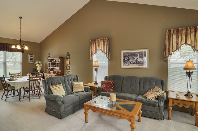 1056 Teasel Lane Aurora, IL 60504 - Photo 6 of 25 a living room with furniture a window and a chandelier