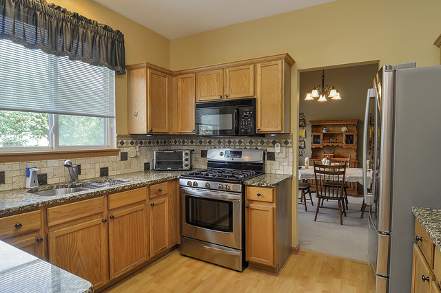 1056 Teasel Lane Aurora, IL 60504 - Photo 9 of 25 a kitchen with appliances a sink and cabinets