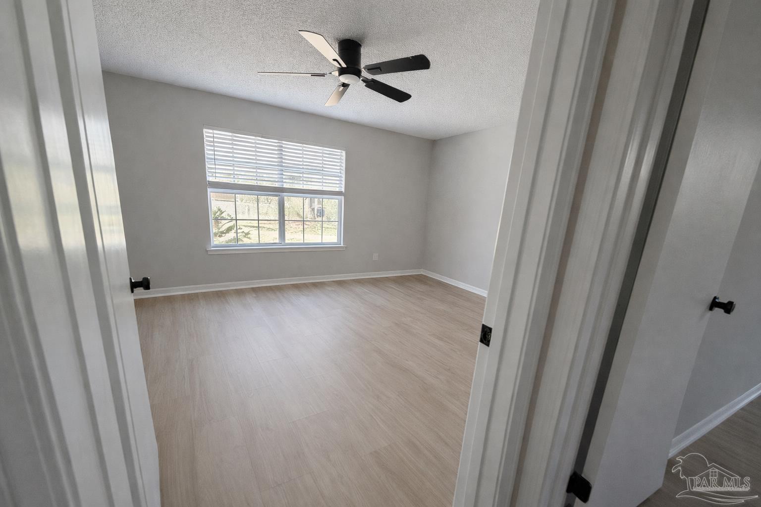 2360 Old Chemstrand Road Cantonment, FL 32533 - Photo 7 of 11 a view of empty room with wooden floor and fan