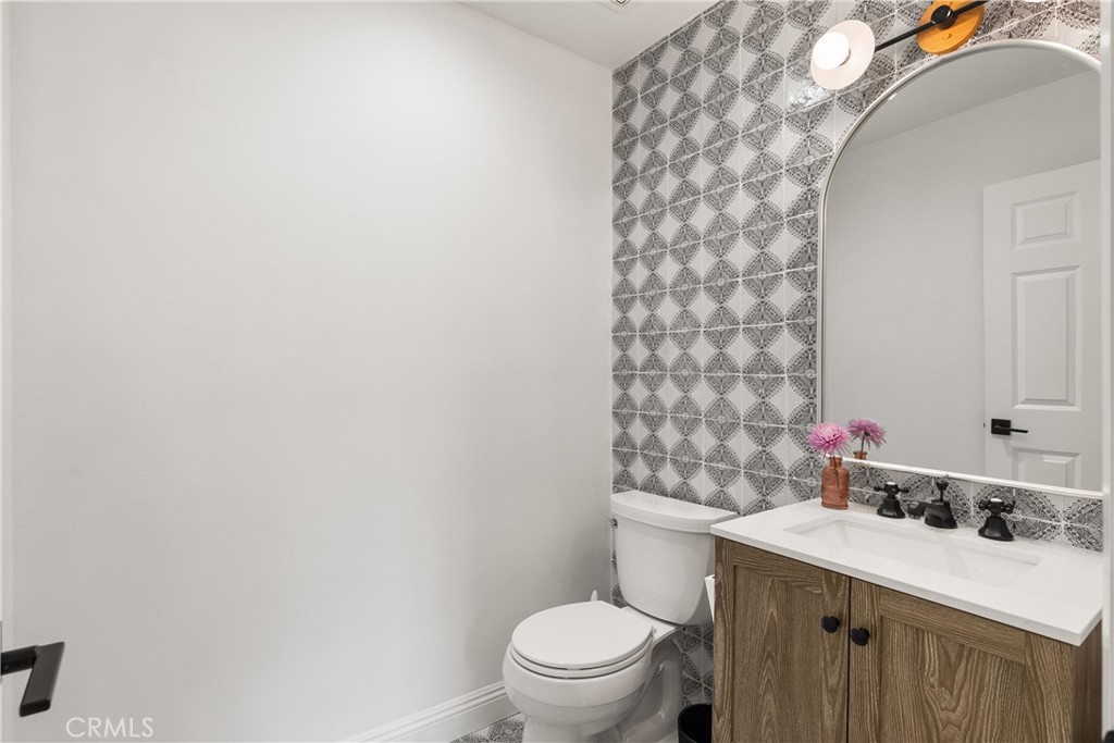 10442 Boca Canyon Drive North Tustin, CA 92705 - Photo 26 of 55 a bathroom with a sink a toilet and a mirror