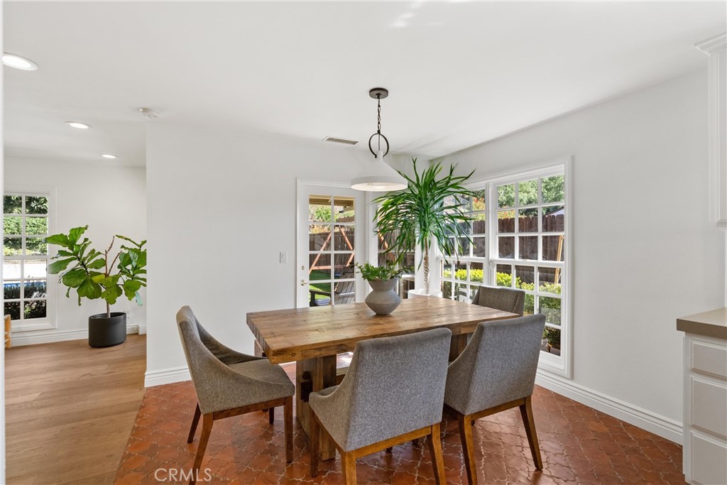10442 Boca Canyon Drive North Tustin, CA 92705 - Photo 28 of 55 a dining room with furniture potted plants and wooden floor