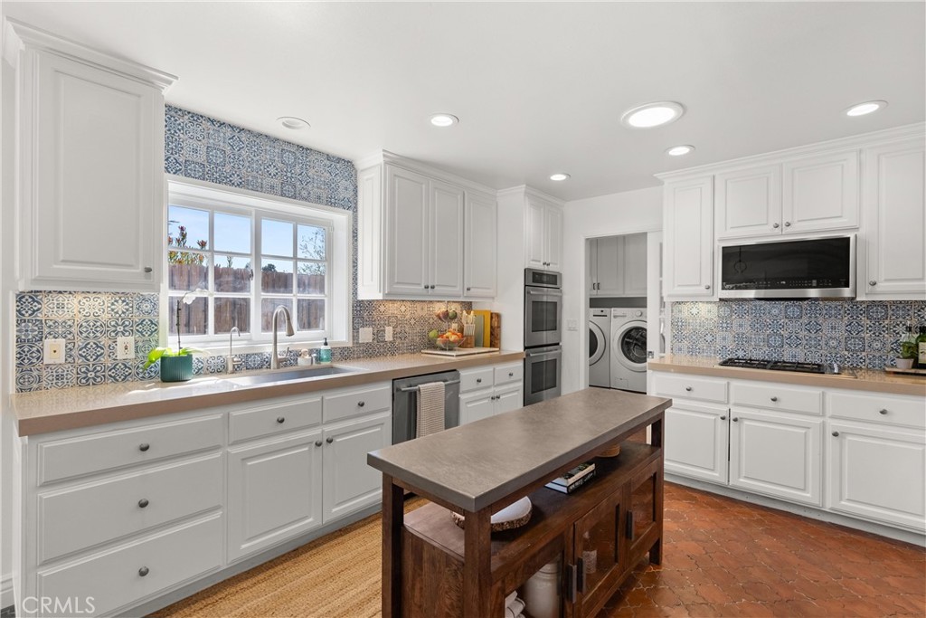 10442 Boca Canyon Drive North Tustin, CA 92705 - Photo 30 of 55 a kitchen with granite countertop a sink counter top space cabinets and stainless steel appliances