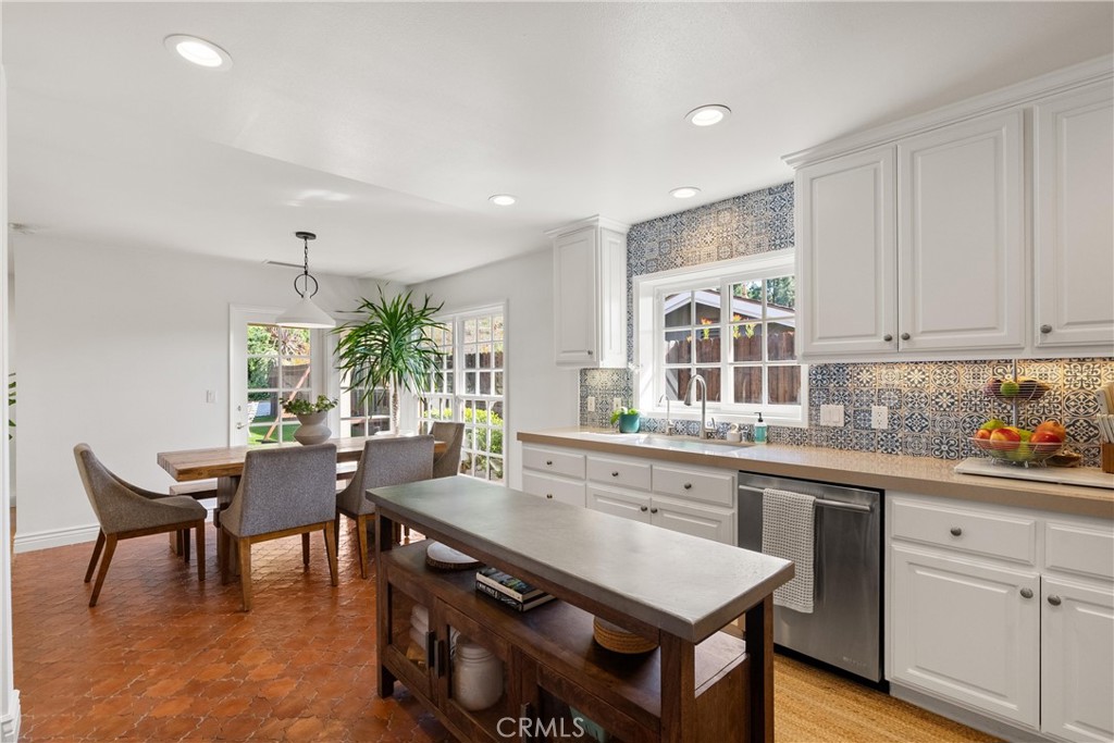 10442 Boca Canyon Drive North Tustin, CA 92705 - Photo 32 of 55 a kitchen with a table chairs stove and white cabinets