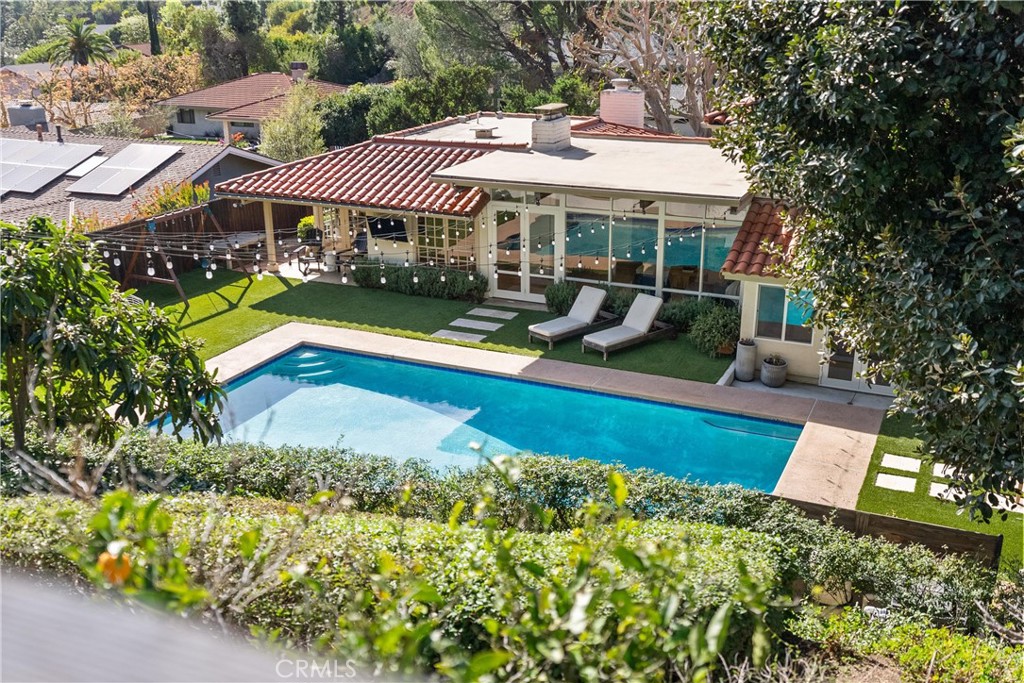 10442 Boca Canyon Drive North Tustin, CA 92705 - Photo 49 of 55 a view of a house with swimming pool lawn chairs and a yard