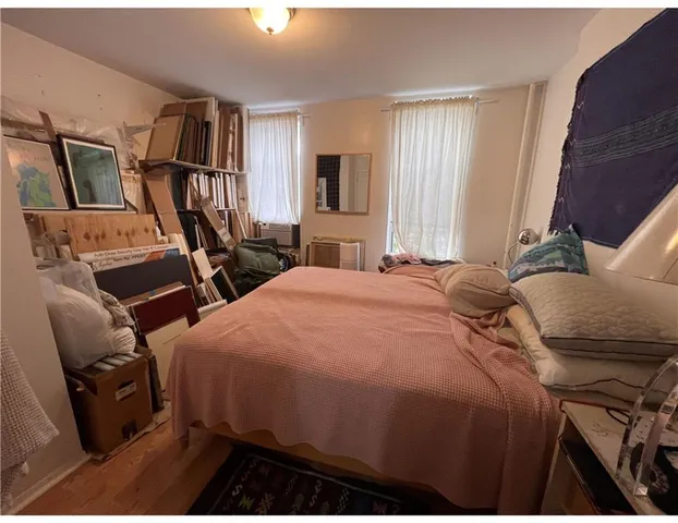 a front view of a house with cars parked