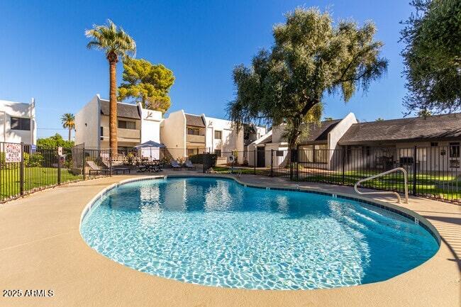 302 East Monte Vista Road, Unit D4 Phoenix, AZ 85004 - Photo 3 of 9 a view of a swimming pool with outdoor seating