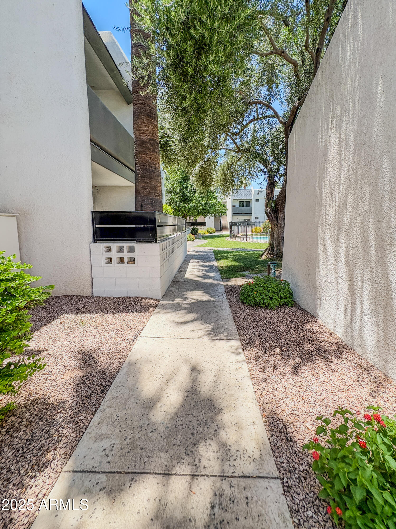302 East Monte Vista Road, Unit D4 Phoenix, AZ 85004 - Photo 4 of 9 a front view of a house with a yard and fountain in middle