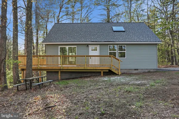 a house that has a small yard and a large tree in it