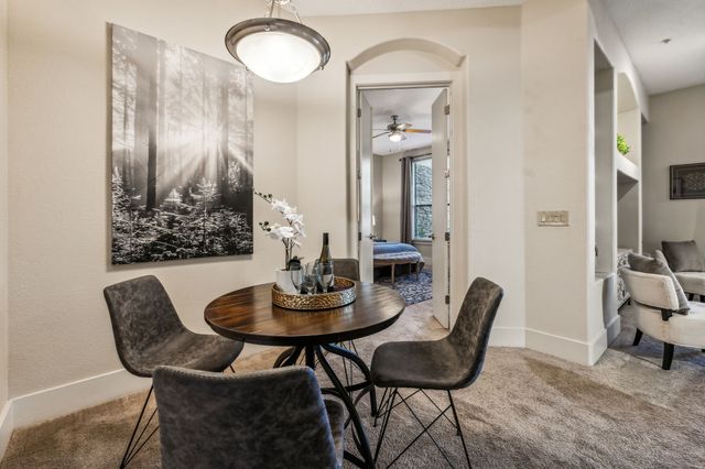 a view of a dining room with furniture and a chandelier