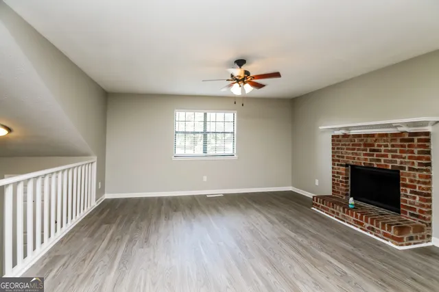 wooden floor in an empty room with a fireplace