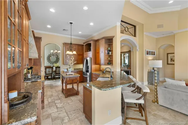 a view of a hallway with wooden floor and a living room