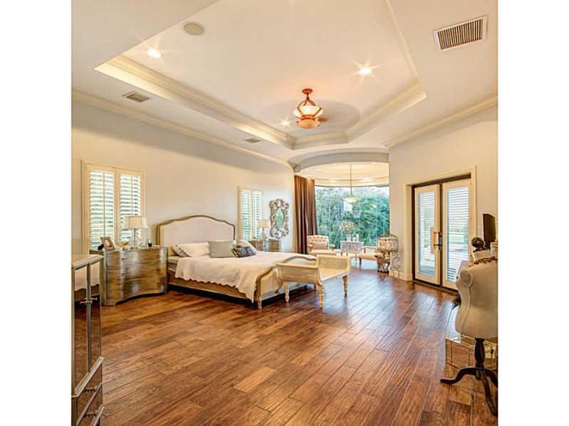 18091 Southwest 66th Street Southwest Ranches, FL 33331 - Photo 16 of 35 a spacious bedroom with a bed and a large window