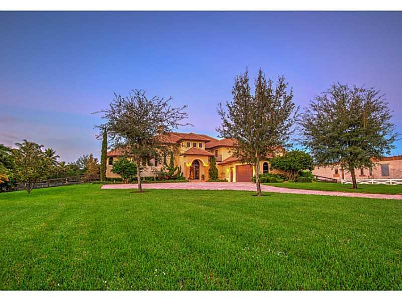 18091 Southwest 66th Street Southwest Ranches, FL 33331 - Photo 2 of 35 a front view of a house with a yard and trees