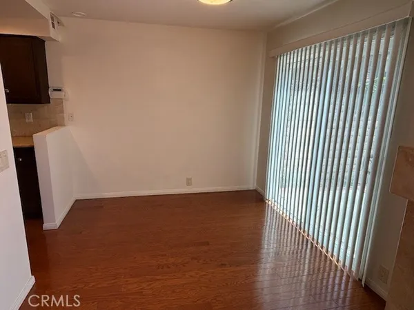a view of a room with wooden floor and staircase