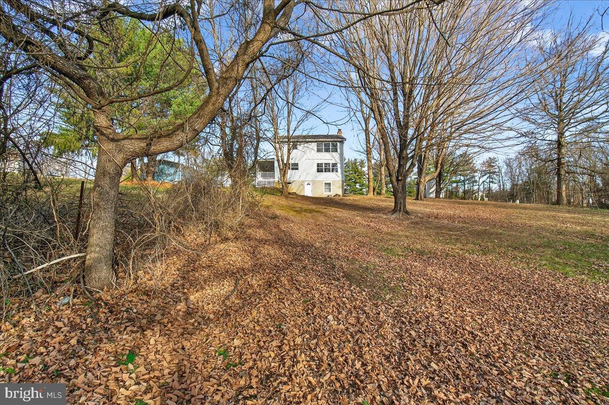 6918 Woodville Road Mount Airy, MD 21771 - Photo 42 of 46 Charming home nestled among autumn leaves.