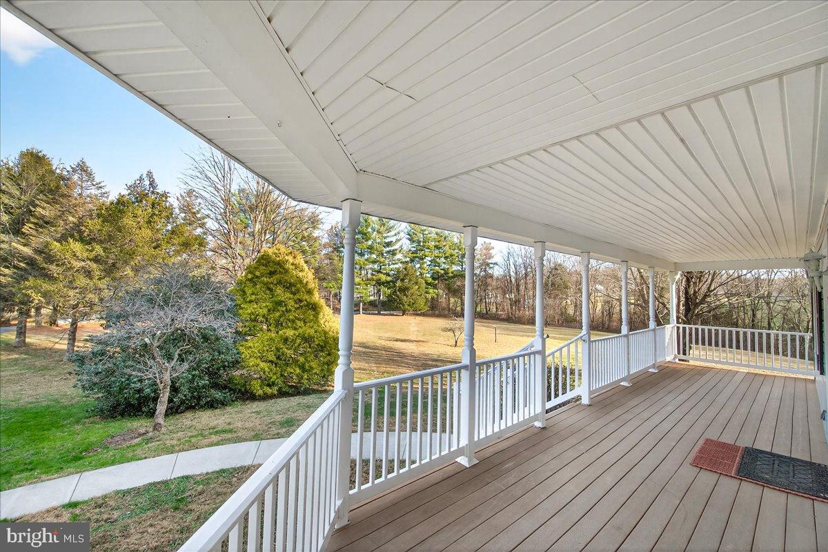 6918 Woodville Road Mount Airy, MD 21771 - Photo 7 of 46 Serene porch overlooking lush greenery.