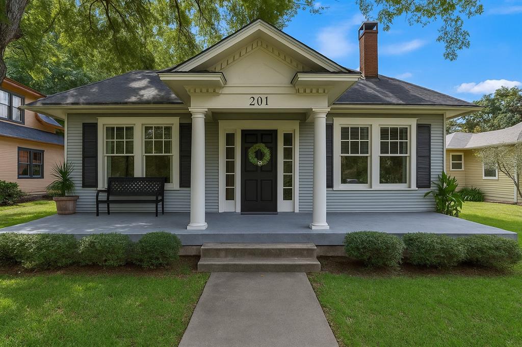 a front view of a house with a yard and porch