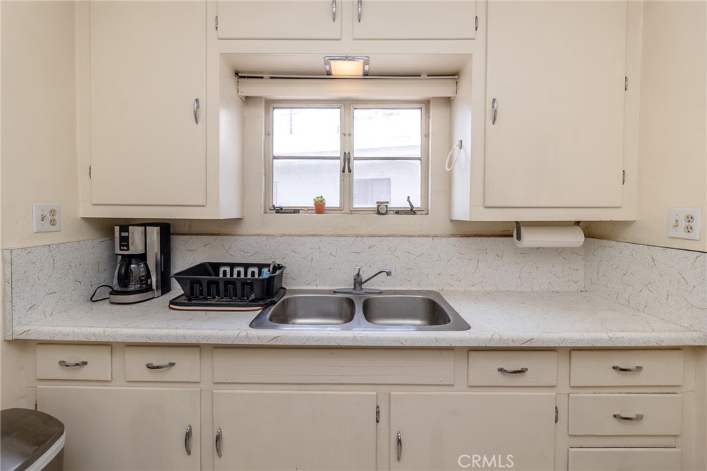 630 Acoma Street Needles, CA 92363 - Photo 40 of 60 a kitchen with stainless steel appliances white cabinets and a window