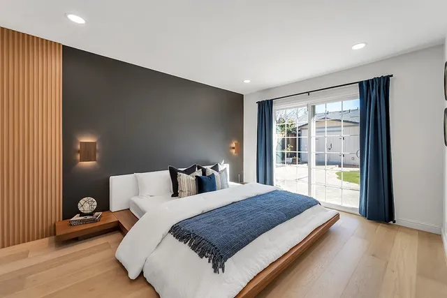 a bedroom with a large bed and a large window