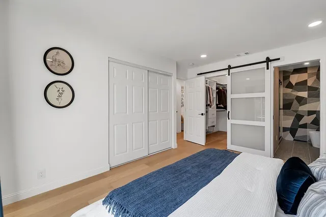 a bedroom with a bed and a window