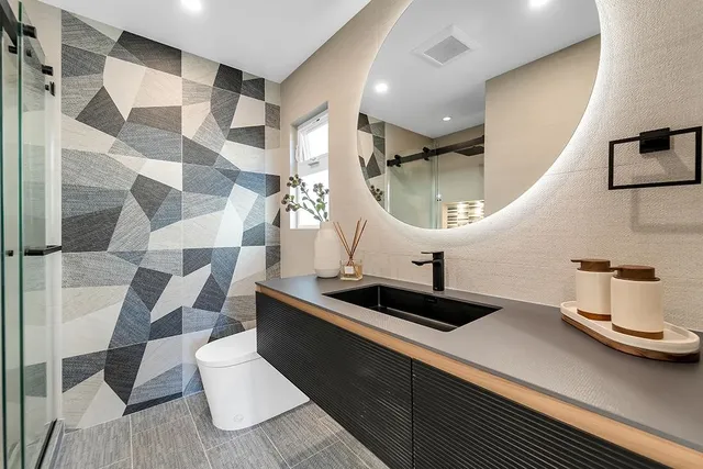 a kitchen with a sink and a mirror