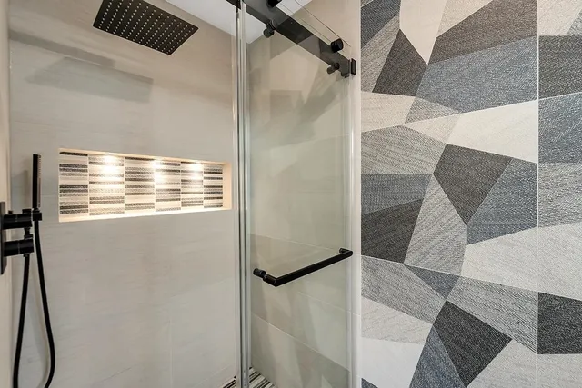 a bathroom with a bathtub and shower