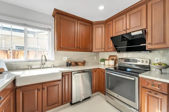 a kitchen with stainless steel appliances a stove a microwave and a refrigerator