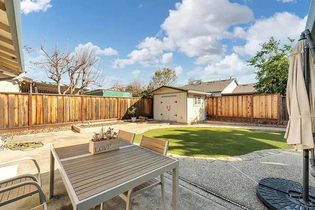 a view of a house with pool and a yard