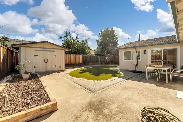 a swimming pool with outdoor seating yard and barbeque oven