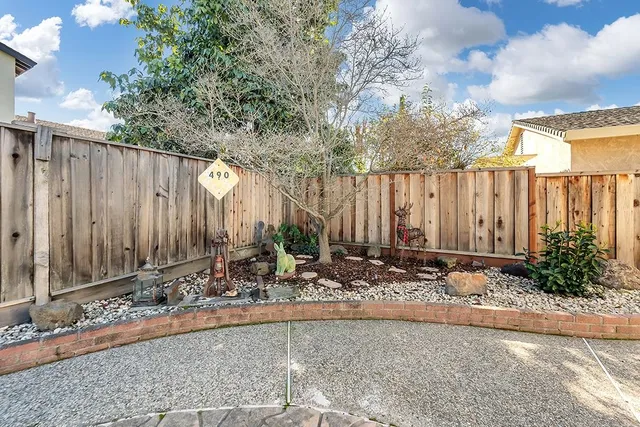a backyard of a house with table and chairs