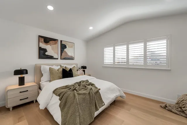 a bedroom with a large bed and a window