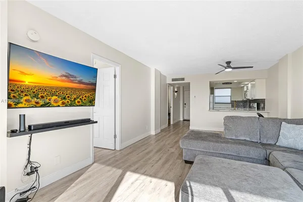 a kitchen with stainless steel appliances kitchen island granite countertop a refrigerator and a stove top oven