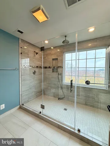 a bathroom with a shower and a sink