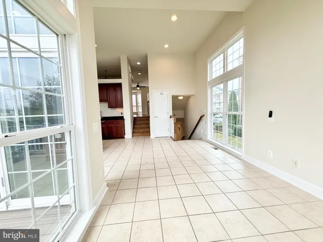 a view of empty room with large windows