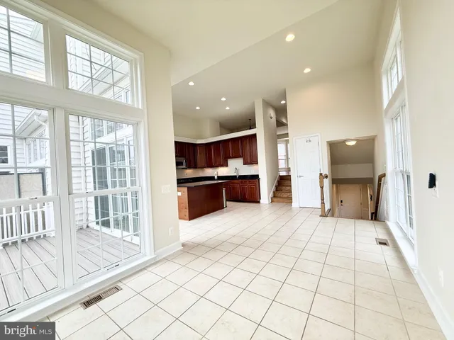 a view of open kitchen with a sink and refrigerator
