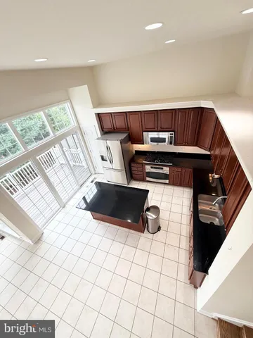 a kitchen with a sink a stove top oven and cabinetry