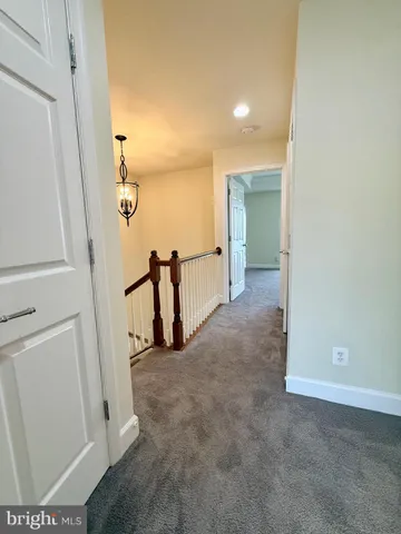 a view of a hallway to rooms