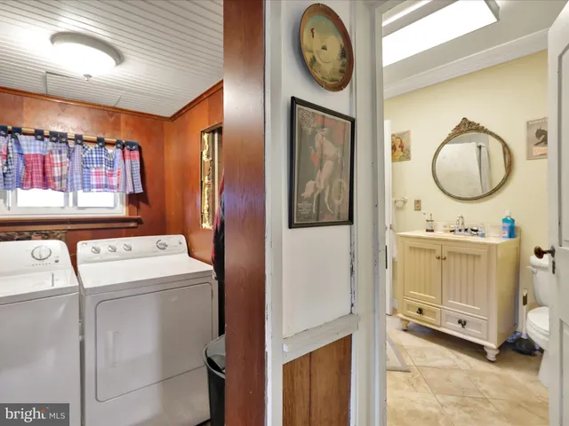 a bedroom with a bed and a large mirror on the dresser